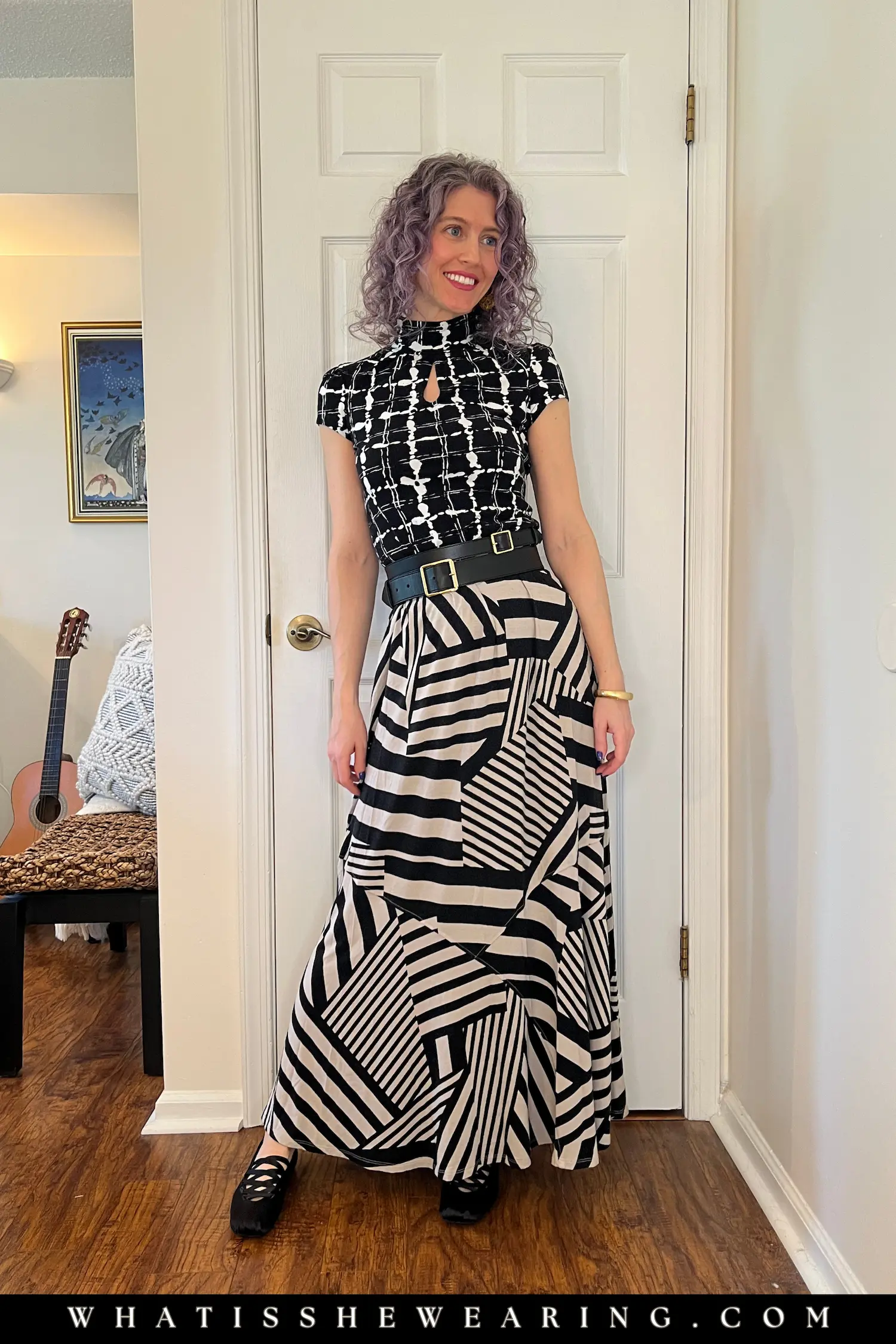 Dopamine dressing skirt outfit featuring mixed prints in black, white, and beige, with a double buckle belt and ballet flats.