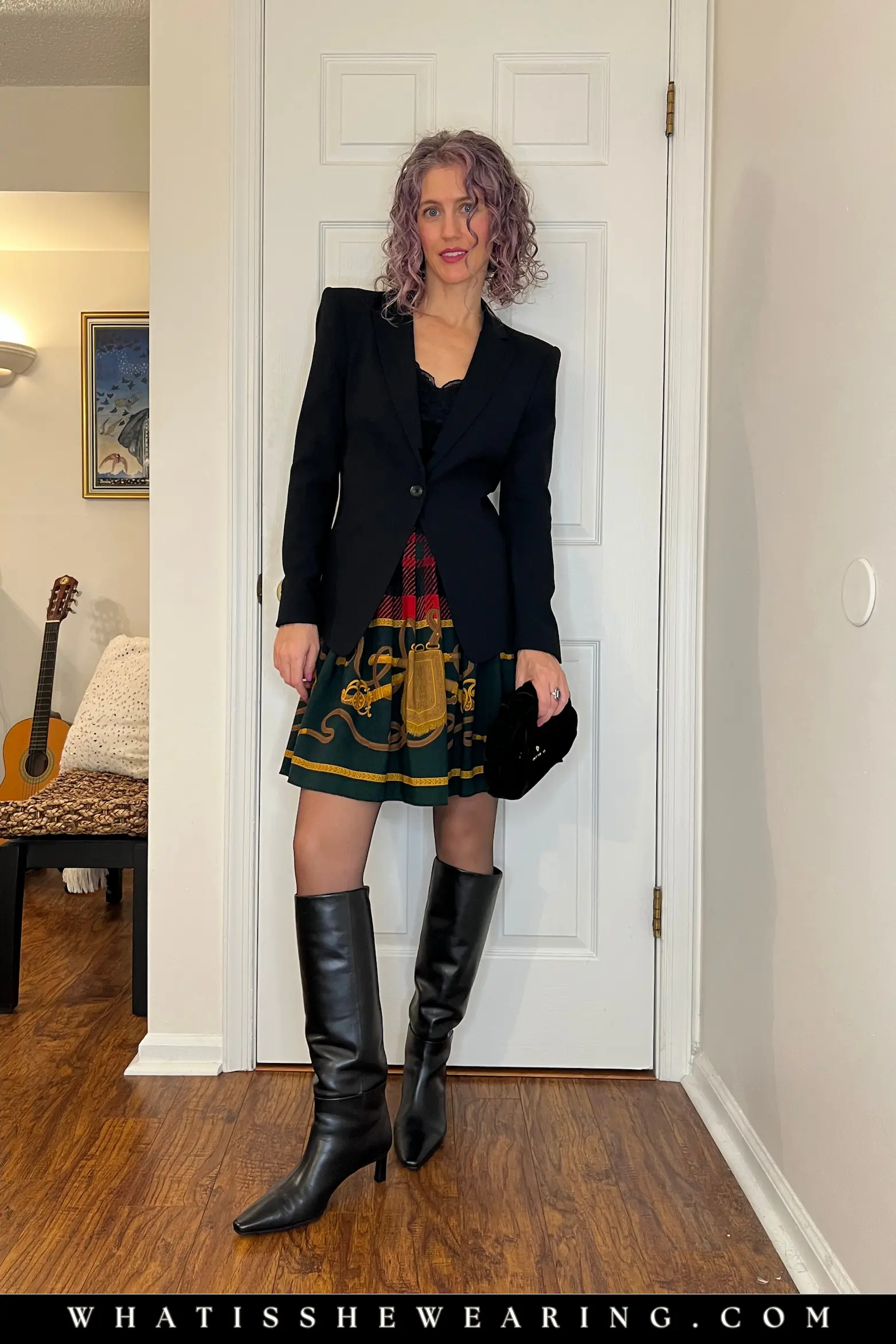 Blazer Plaid Skirt Festive Ensemble Chic office-to-party holiday outfit ideas featuring tailored black blazer over lace top with pleated plaid skirt and tall boots for festive holiday outfits.