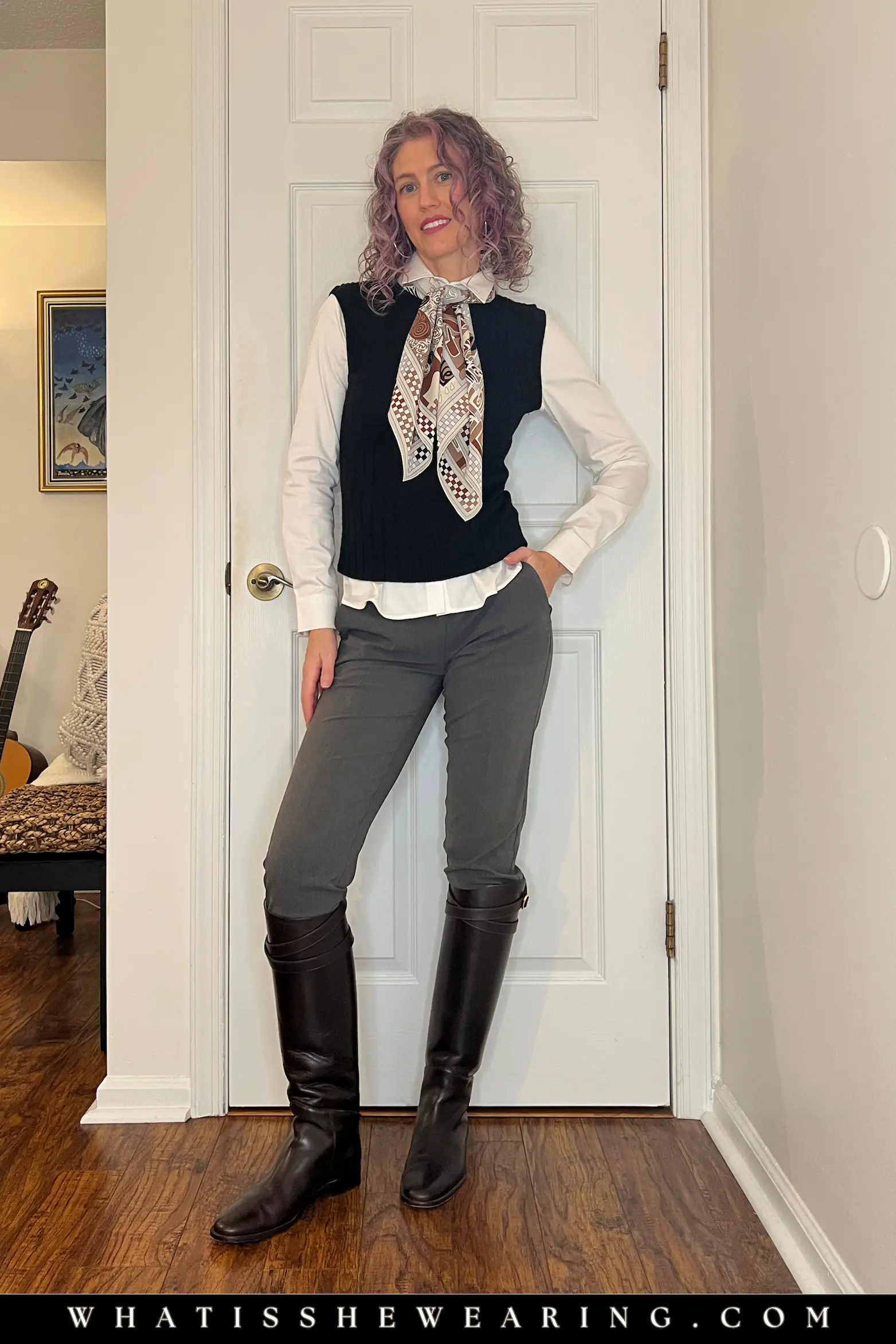 Riding boots with pants: slim trousers, sweater vest, button-down shirt, and patterned scarf for workwear