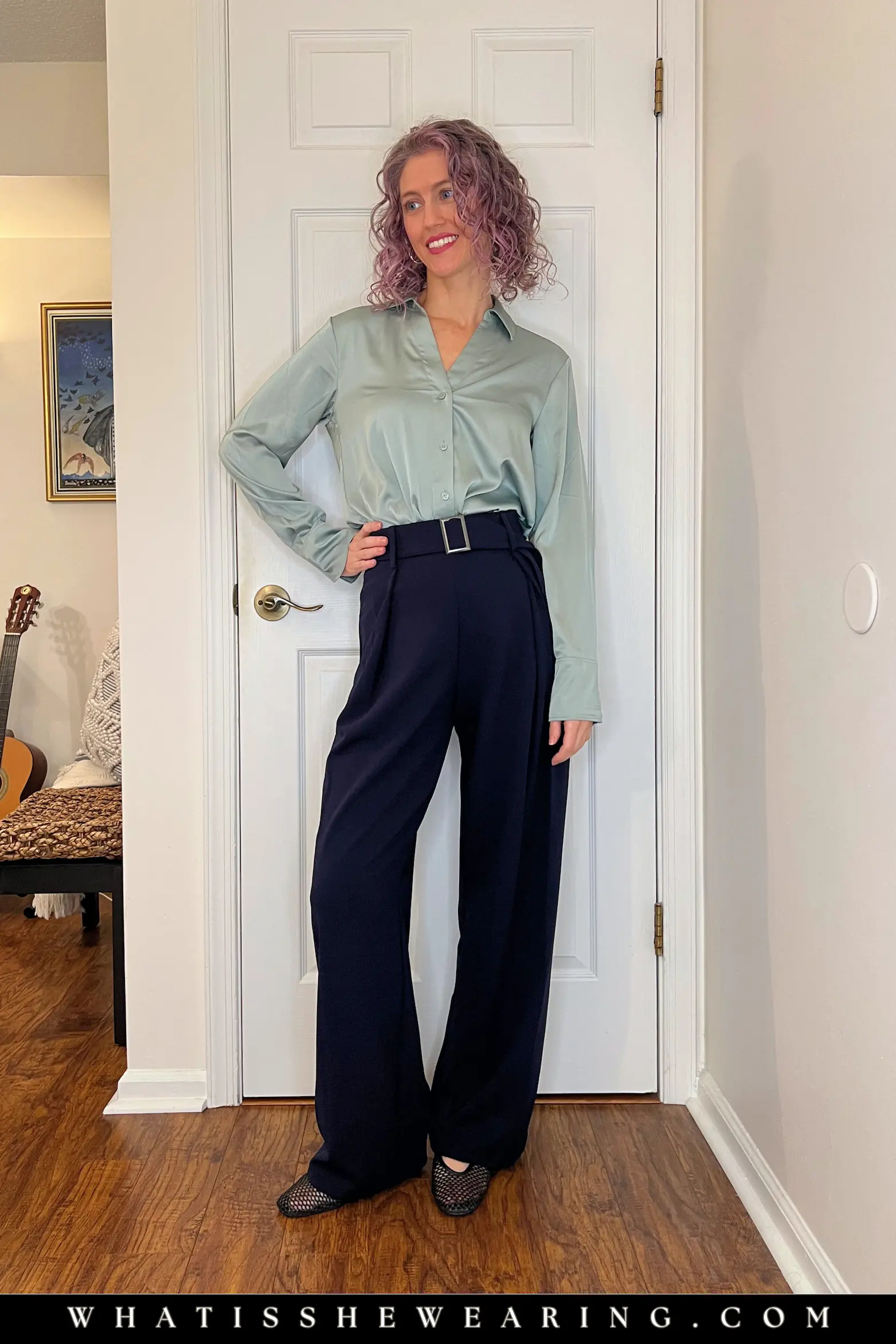 Soft Navy and Sage Green Office Outfit Woman modeling soft classic navy blue look with sage green silk blouse and mesh ballet flats—what to wear with navy blue for muted elegance and grounding calm.