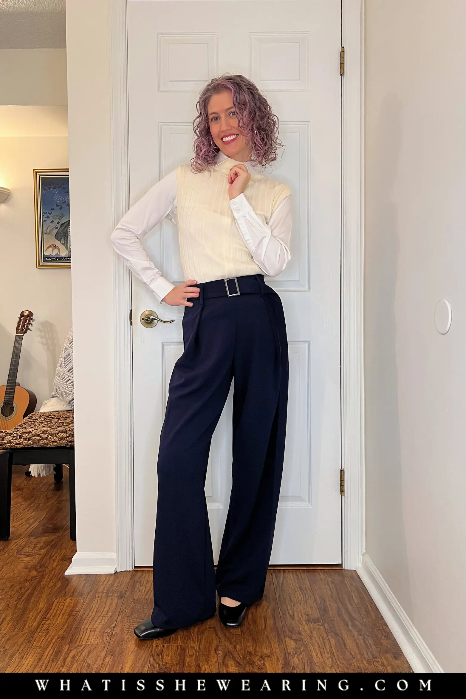 Navy Blue Work Look with White and Ivory Woman in professional navy blue work outfit featuring a crisp white shirt and ivory sweater vest—what to wear with navy blue for timeless nautical freshness and everyday polish.