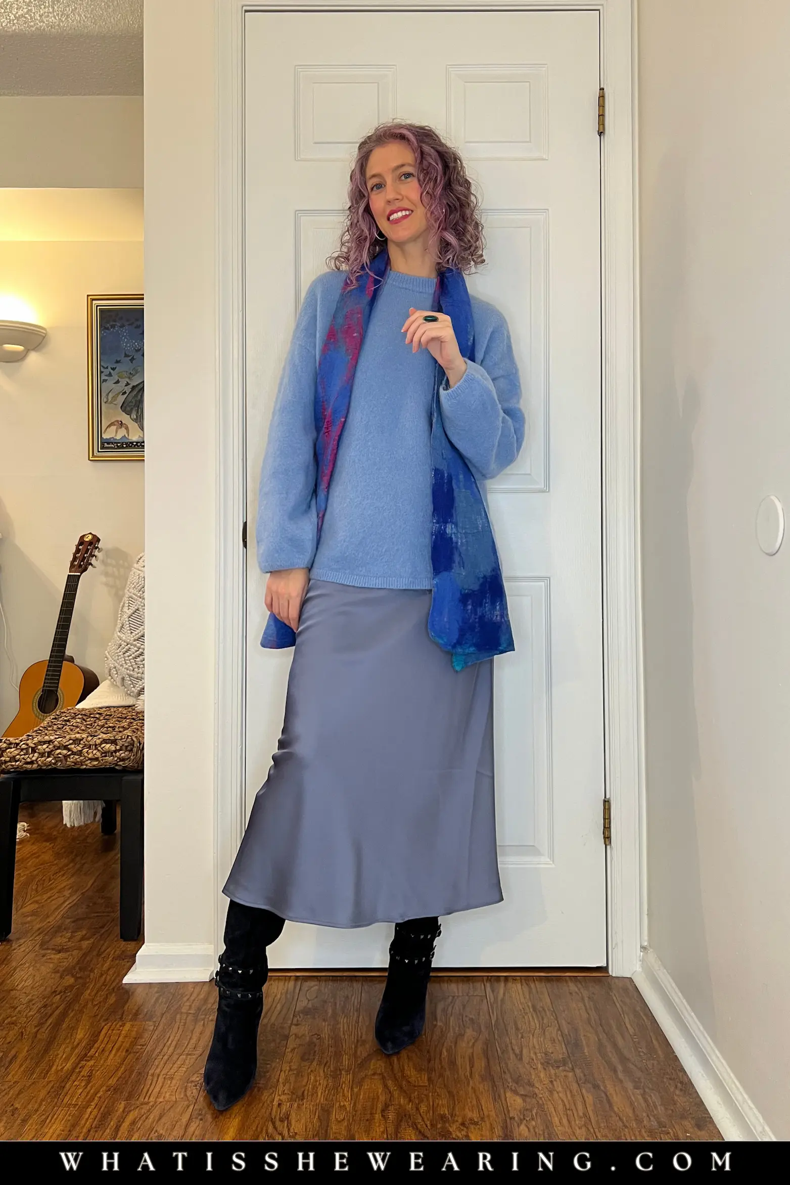 Blue Crewneck Sweater with Satin Slip Skirt and Tall Boots Oversized sweater with skirt: Large blue crewneck over satin slip skirt, navy suede tall boots, and patterned wool scarf for cozy winter vibes.
