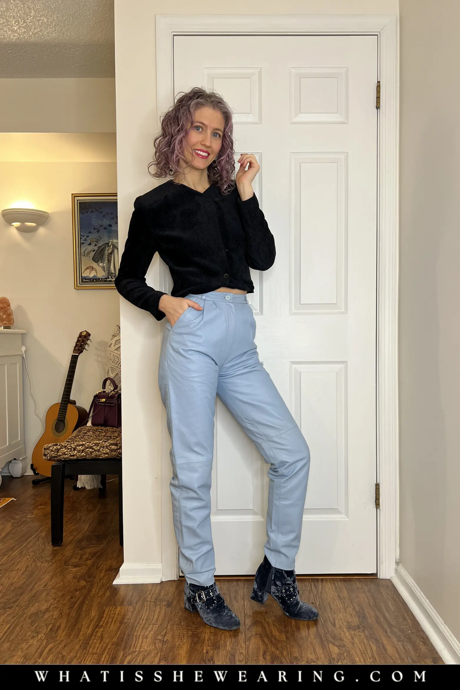 Cropped Navy Jacket with Light Blue Leather Pants Woman in cropped navy jacket paired with high-waisted soft blue leather pants and blue ankle boots, flattering cropped spring jacket style