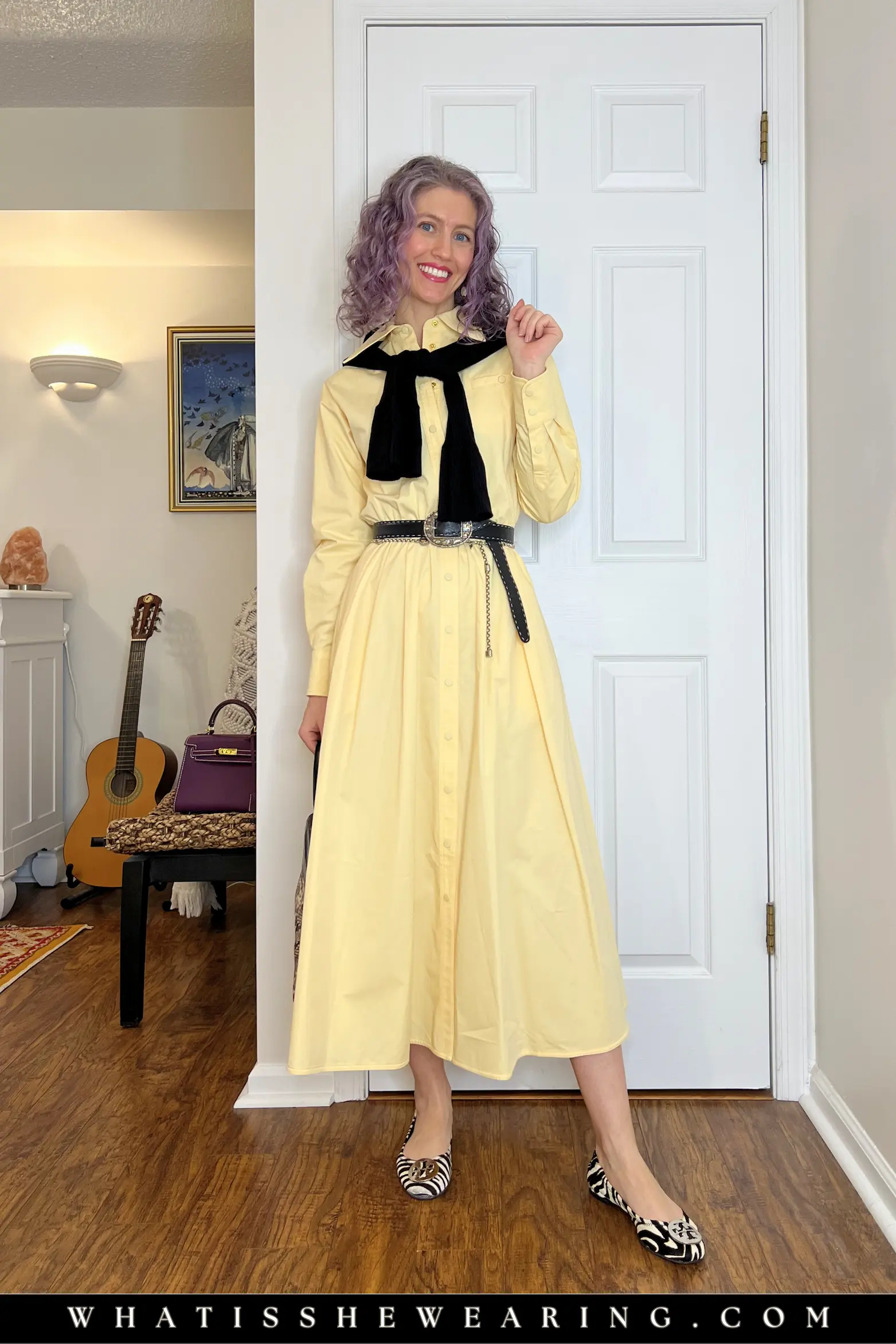 Outfit Idea 5: Belted Butter Yellow Shirt Dress with Zebra Flats Woman in belted butter yellow shirt dress with black cardigan tied around shoulders and zebra print pony hair ballerina flats – fresh spring workwear vibe