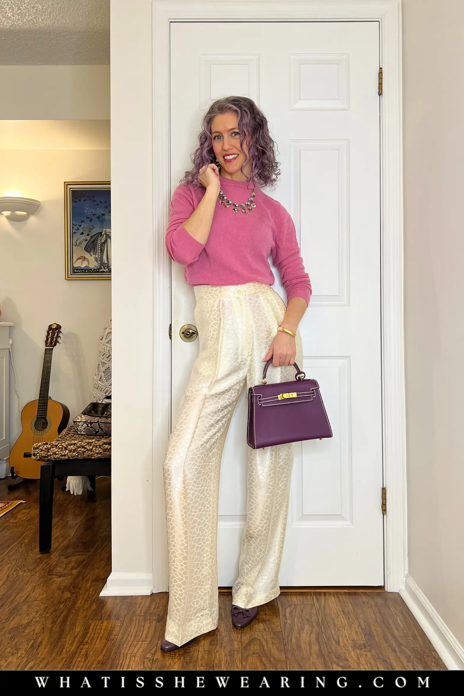 Outfit Idea 2: Pink Cashmere & Ivory Satin Trousers Woman wearing pink cashmere crewneck sweater and ivory satin trousers with purple slingback pumps and matching purple handbag – elevated spring work outfit